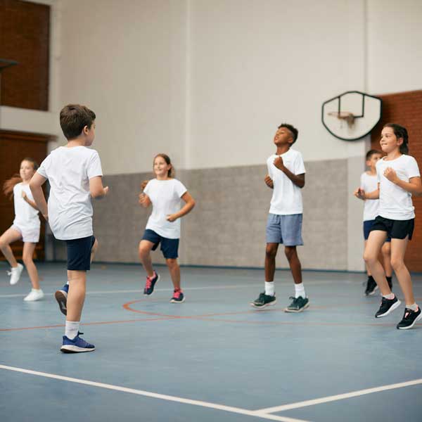 AdobeStock_605997179_Preview kids in gym class exercising