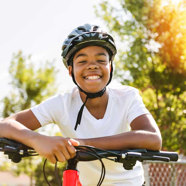 AdobeStock_605997179_Preview smiling boy on bike