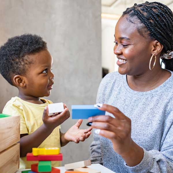 preschooler and blocks with woman