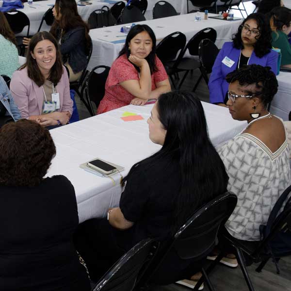 people sitting around table at Systems in Sync