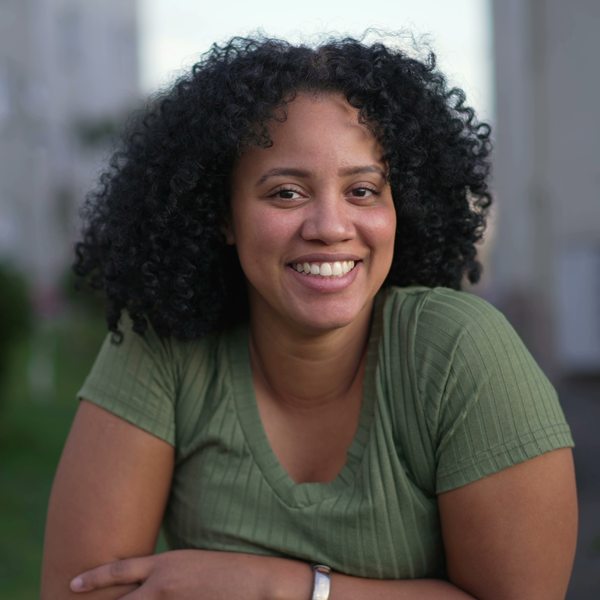 woman in green shirt smiling